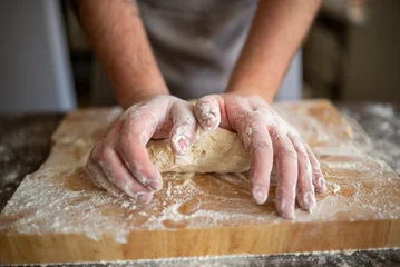 Close up of flour-covered hands kneading dough © Nomad_Soul