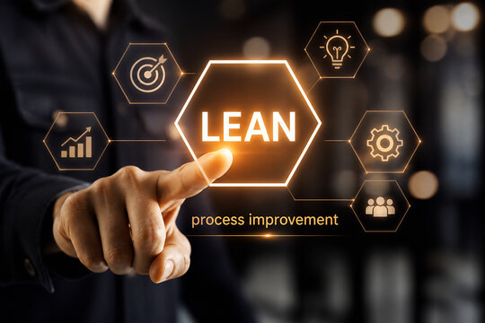 A person points at a glowing hexagonal graphic displaying the word LEAN for process improvement in a dark setting.