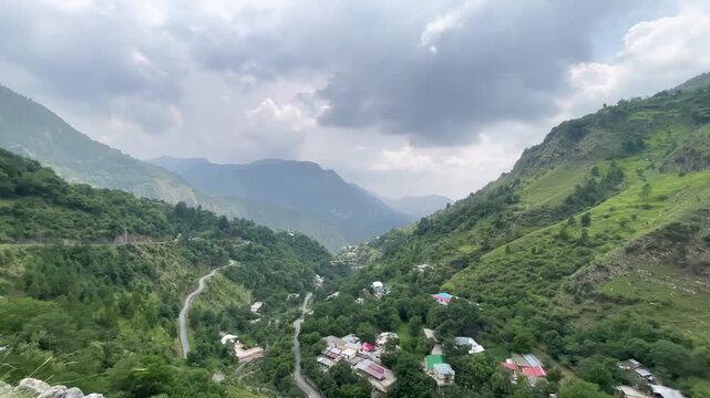Scenic Mountain Valley with Winding Road and Dramatic Cloudy Sky in Abbottabad, Khyber Pakhtunkhwa, Pakistan
