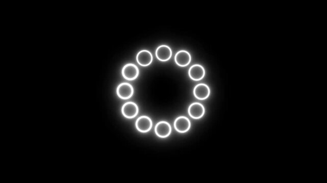 Bright white glowing circular loading indicator composed of twelve small rings arranged in a circle on a solid black background for user interface