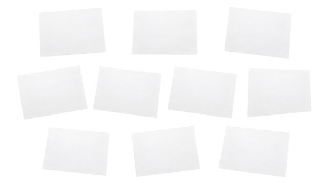Ten blank white square sticky notes or paper pieces, casually arranged and overlapping.