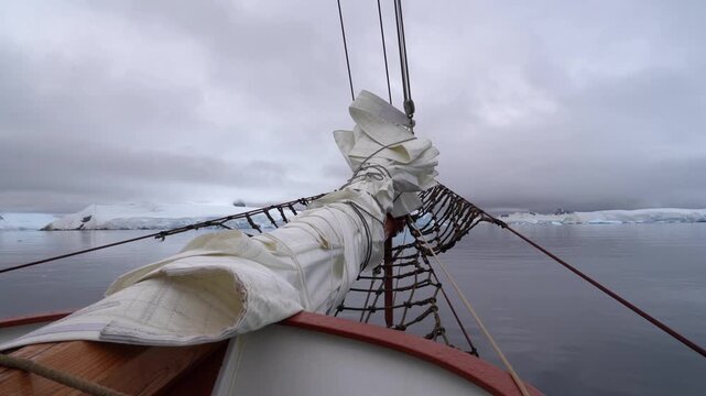 Cinematic POV shot from the bowsprit of the Schooner Amazone sailing through the Errera Channel toward Georges Point, Rong&eacute; Island, Antarctica
