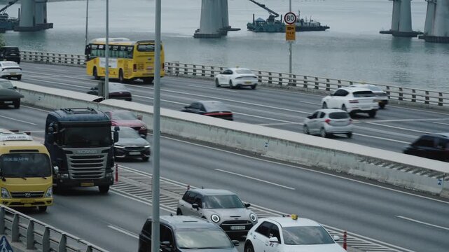 Highway traffic with cars driving across Seoul Han river bridge.
