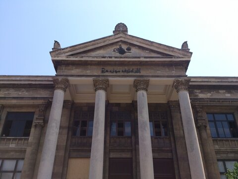 Istanbul, Turkey - August 1, 2014: Exterior neoclassical facade of the Istanbul Archaeology Museum featuring monumental columns and Ottoman inscriptions on a sunny day. 