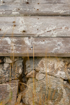Weathered wooden boards and stone foundation texture background.