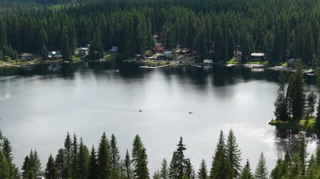 Aerial of Gillette Lake in Colville National Forest in Washington in summer with kayakers and private boat docks