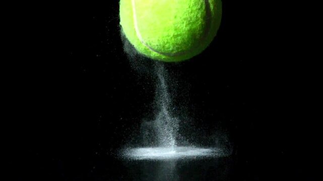 Tennis Ball Bouncing With Dust On Black Background