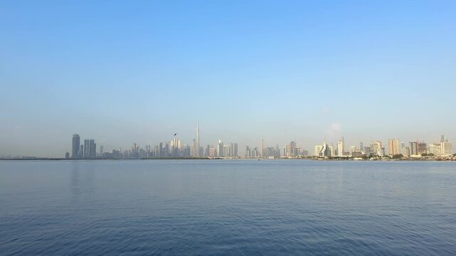 Wide panoramic view of Downtown Dubai and Burj Khalifa across Dubai Creek. Iconic waterfront skyline remains one of most recognized travel destinations in United Arab Emira