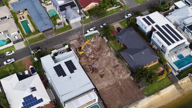 Aerial View of Excavator Working on Waterfront Residential Construction Site