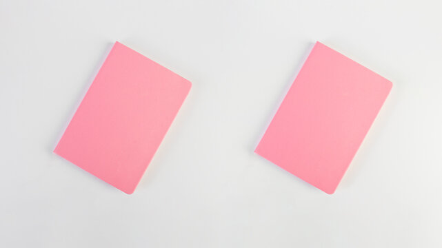 A pink notebook, a note-taking notebook against a white background. 