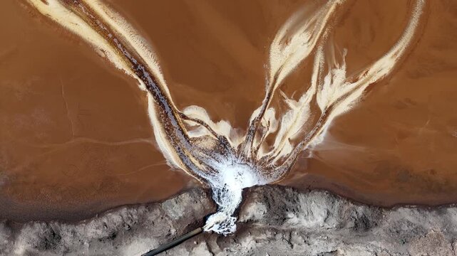 Aerial view of industrial wastewater discharge polluting a river