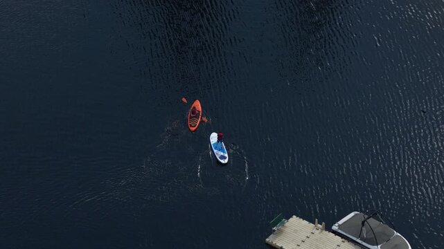 Aerial close up of recreational paddling on Gillette lake in Stevens County Washington in summer time with stand up paddle pard and kayak