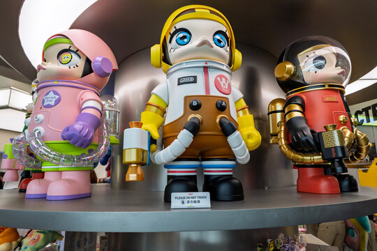 Singapore - January 21, 2026: A close-up commercial shot of large Pop Mart Mega Space Molly designer toy figures showcased on a circular metallic shelf inside a retail store.