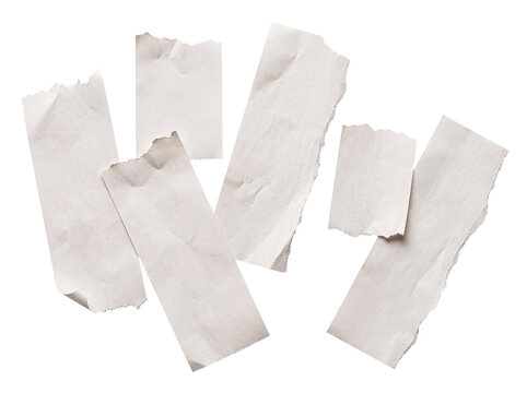 Scattered collection of various crumpled, torn paper pieces with rough edges and textured surface.