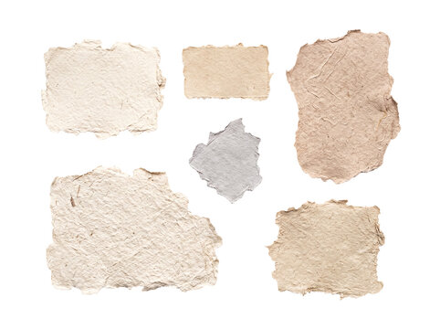 Abstract composition of torn aged handmade paper pieces, ideal for backgrounds, textures, or creative designs.