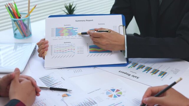 Corporate professionals reviewing business graphs and financial reports. Data analysis, teamwork, marketing strategy, investment, leadership, performance, success, 4K.