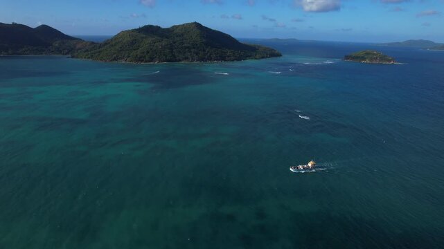 A small cargo ship arriving at Praslin Island in the Seychelles. Aerial view