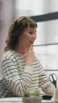 360 Degree Vertical Screen. Focused Caucasian Woman Sits at Office Desk, Typing on Laptop Computer to Browse the Internet, Handle Everyday Work Tasks and Stay Productive. Cinematic Arc Tracking Shot.