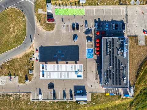 Aerial view of a service station along the Droga Ekspresowa S5, featuring solar panels on the roof, parking spaces, and surrounding landscape in Gruczno, Kuyavian-Pomeranian Voivodeship, Poland.