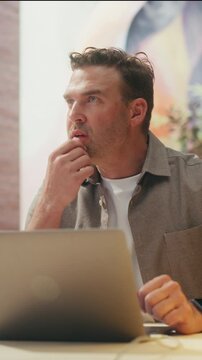 360 Degree Vertical Screen. Man Works at Office Desk, Typing on Laptop Computer to Complete Everyday Business Tasks, Browse the Internet and Stay Productive at Work. Cinematic Arc Tracking Shot.