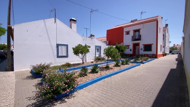 Rustic outdoor patio with various potted plants, wooden bench, and simple kitchen area under a relaxing sunshade