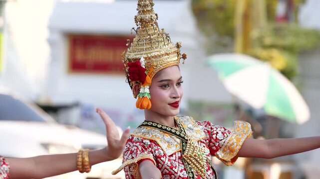 Traditional Thai Dancer Performing in Golden Headdress and Ornate Costume