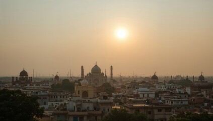 Fototapeta premium Sunrise Over the City With the Landmark Structure in the Distance and Buildings in the Foreground