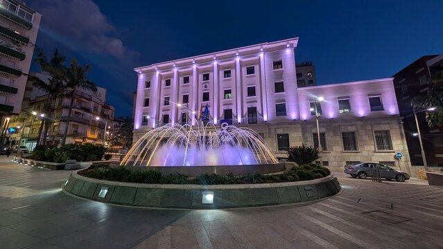 An illuminated fountain in a plaza in the city of Ceuta, Spain