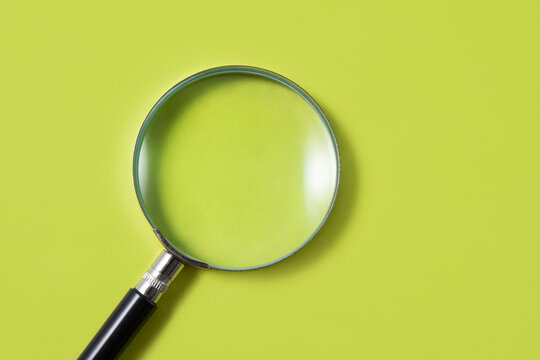 magnifying glass on green background