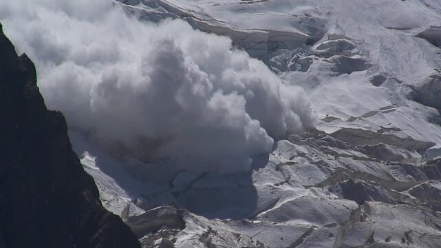 Caucasus, Bezengi Gorge. A snow and ice avalanche falls down a steep mountain slope.