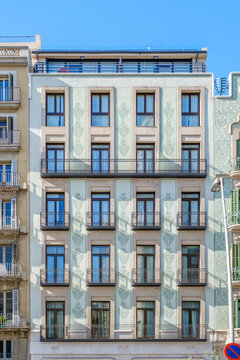 Classic Building Facade with Green Sgraffito Ornaments and Balconies in Barcelona, Modernist Eixample Architecture, Residential House