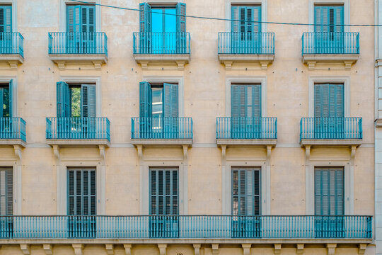 Barcelona, Classic Building Facade with Turquoise Shutters and Balconies, Eixample Architecture, Symmetric Windows Pattern