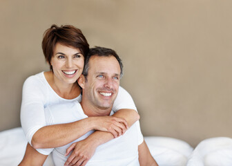 Fototapeta premium Thinking, morning and relax with couple in bedroom for romance, valentines day and marriage. Vision, getaway and space with mature man and woman in home or staycation for anniversary retreat and love
