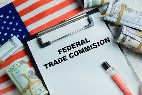 Concept of federal trade commission write on clipboard isolated on Wooden Table. For consumer protection and antitrust enforcement