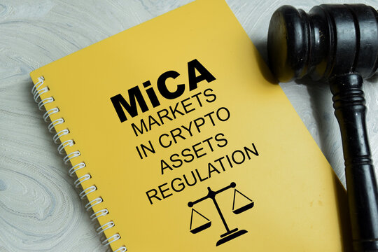 Concept of MiCA market in crypto-assets regulation write on book isolated on Wooden Table. For highlighting European crypto compliance framework and digital asset governance