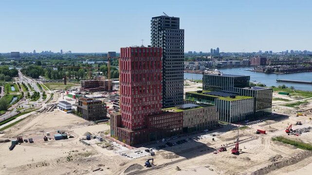 Aerial photo of residential towers and new construction projects on Zeeburgereiland in Amsterdam. In the background, the IJmeer and the Amsterdam skyline.