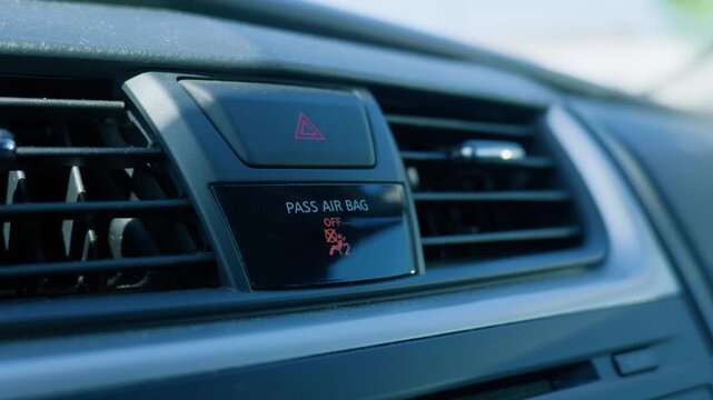 Car dashboard displaying passenger airbag off indicator light