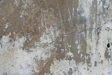 Fototapeta premium Distressed concrete wall texture with peeling plaster and weathered surface background