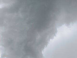 Fototapeta premium Dark grey storm clouds filling the sky. Heavy overcast weather indicating impending rain. Moody and dramatic atmospheric background