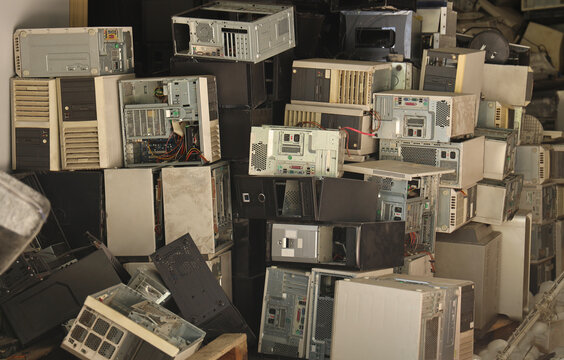 Stacks of old personal computers and pc cases Pile of electronic waste Rusty old computer cases and obsolete computer hardware such as motherboards and CD-ROMs floppy disk isolated on white background