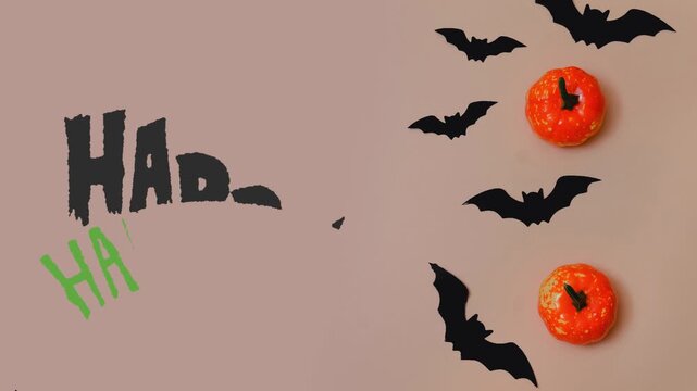Mischievous Halloween setup with flying bat silhouettes, cheerful 'HA HA' text, and vibrant decorative pumpkins for a fun celebration