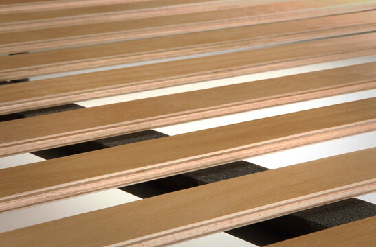 Close up of a bed base, with wooden slats