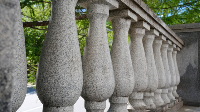 Classic stone balustrade with concrete balusters in a historic city. Architectural gray background with classic decorative railings on the terrace.
