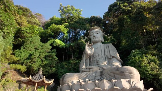 The iconic stone Buddha statue at Chin Swee Caves Temple in Genting Highlands sits gracefully on a lotus pedestal