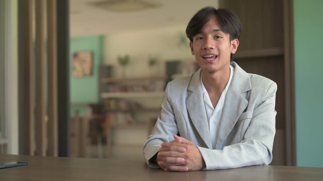 Portrait of young person from Southeast Asia Thai Isan region vlogging talking to camera