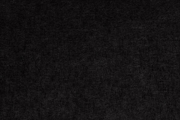 Fototapeta premium Macro 1:1 close-up of black cardstock paper showing a fine fibrous texture, ideal for stationery, packaging, and elegant minimalist design background projects.