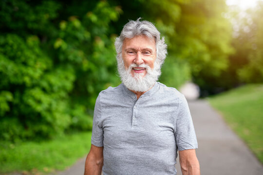 Senior man walk in the forest on a summer day