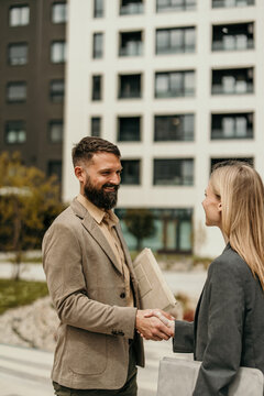 Business partners shaking hands making deal outdoors