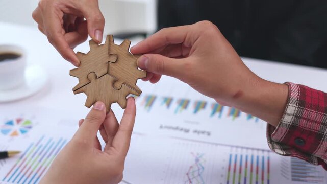 Corporate professionals solving a puzzle together in a modern office. Business teamwork, collaboration, planning, communication, leadership, growth, success, 4K.