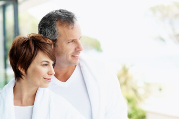 Fototapeta premium Smile, thinking and balcony with couple at hotel for travel, anniversary getaway or love. Marriage, holiday villa and hospitality with man and woman relax at resort for view, vision or space